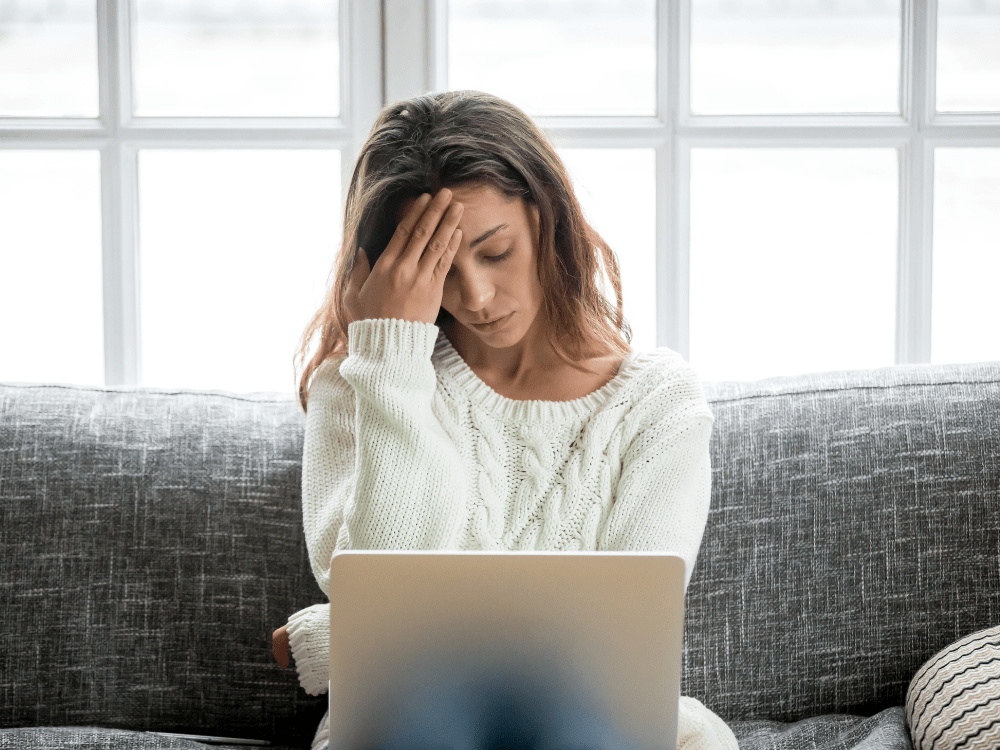 frustrated woman sitting in front of her laptop