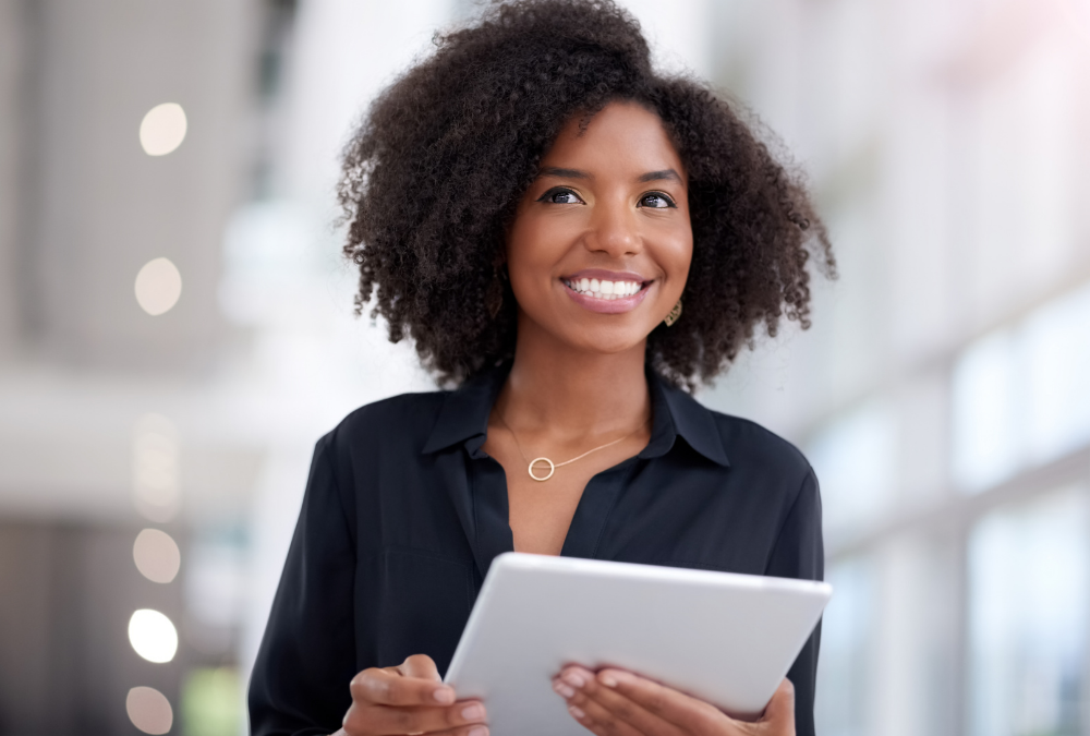 happy black woman at work with papers in hand